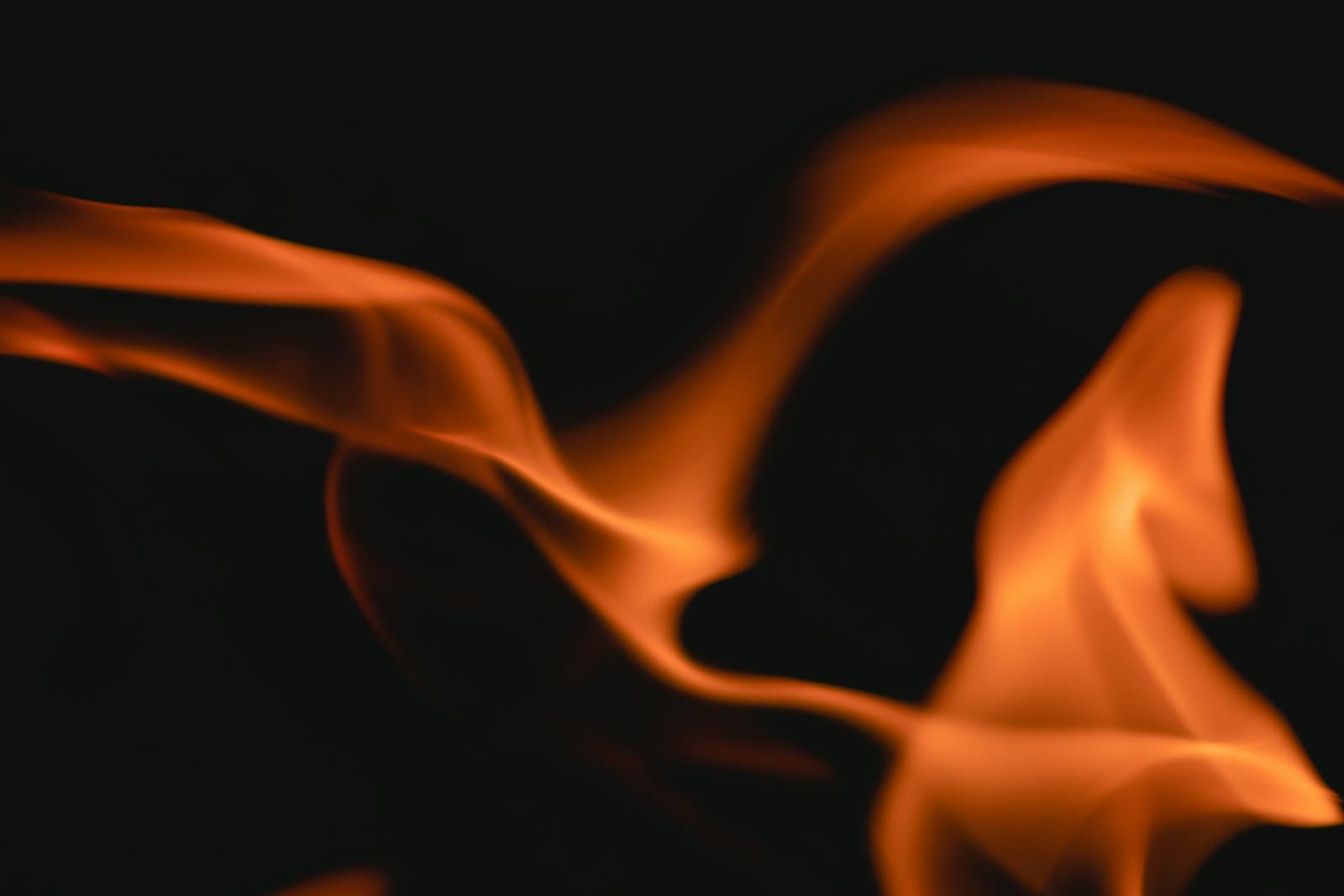 Soft flame and smoke against black — the sacred altar fire