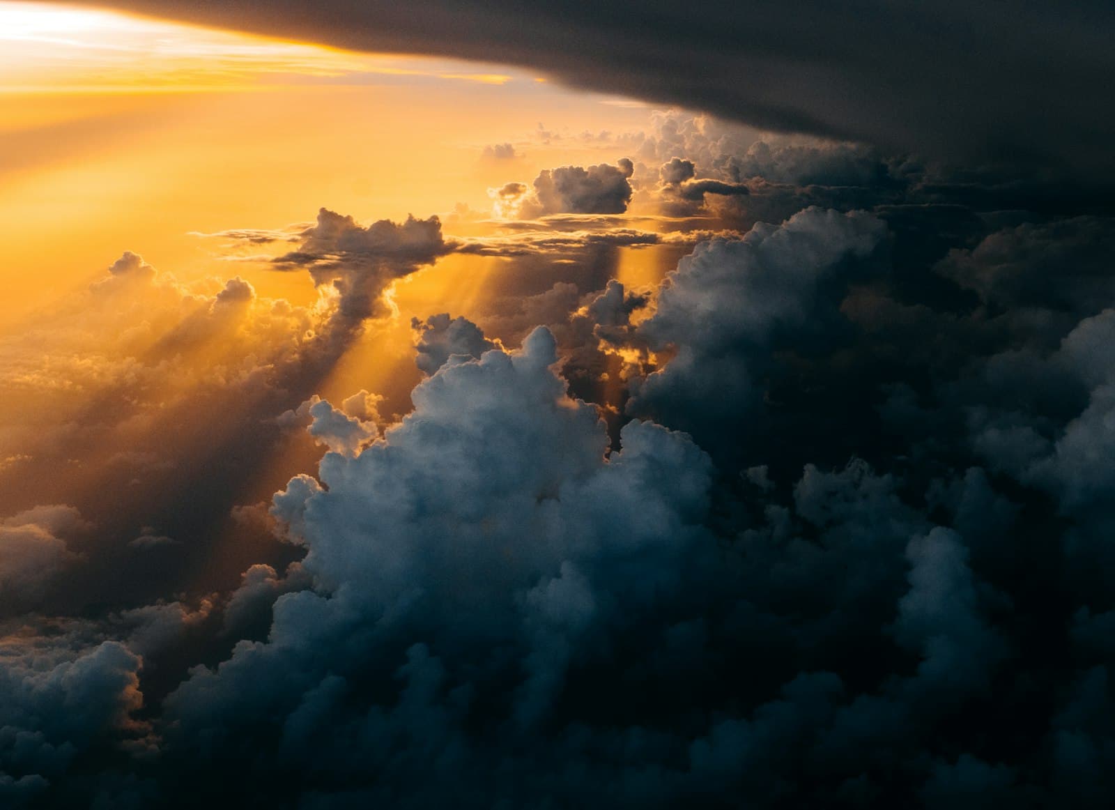 Golden light breaking across a sea of cloud — the messianic vision