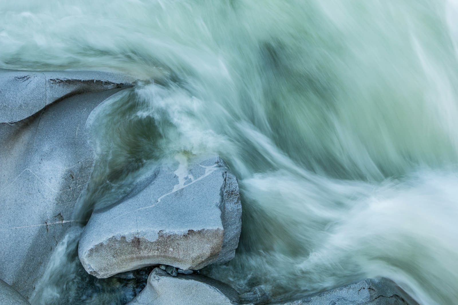 Water sweeping powerfully over stone — justice rolling like mighty waters