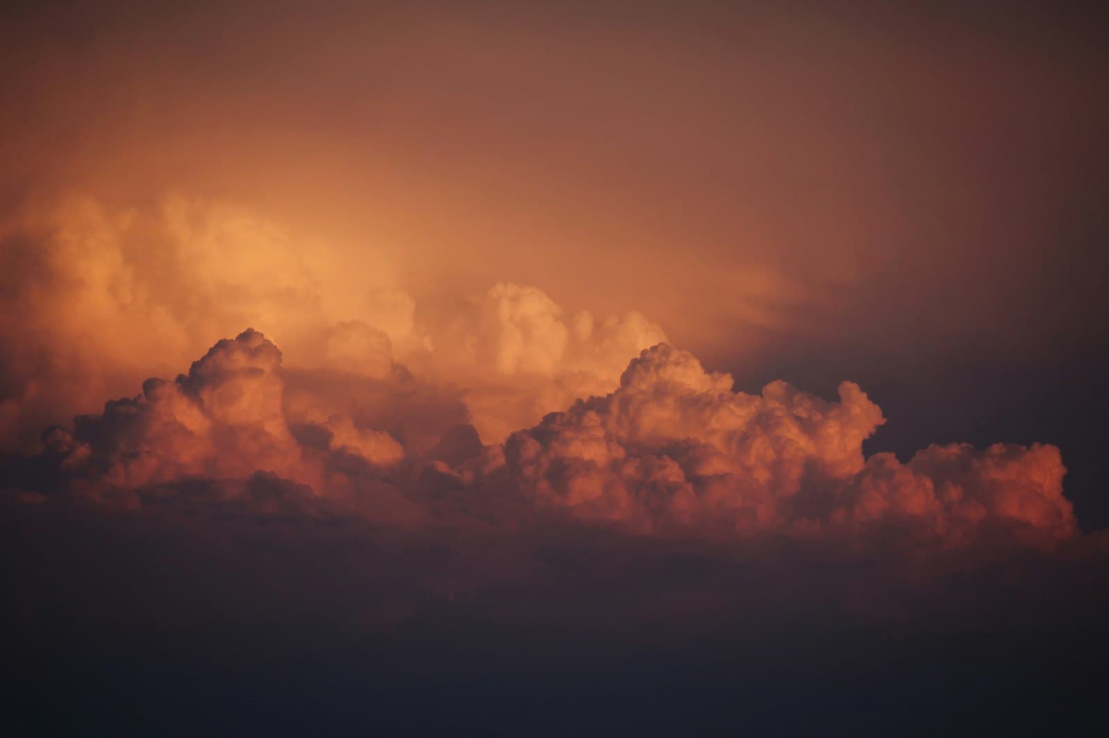 Fire-lit smoke rolling over a dark ridge — the day of the Lord
